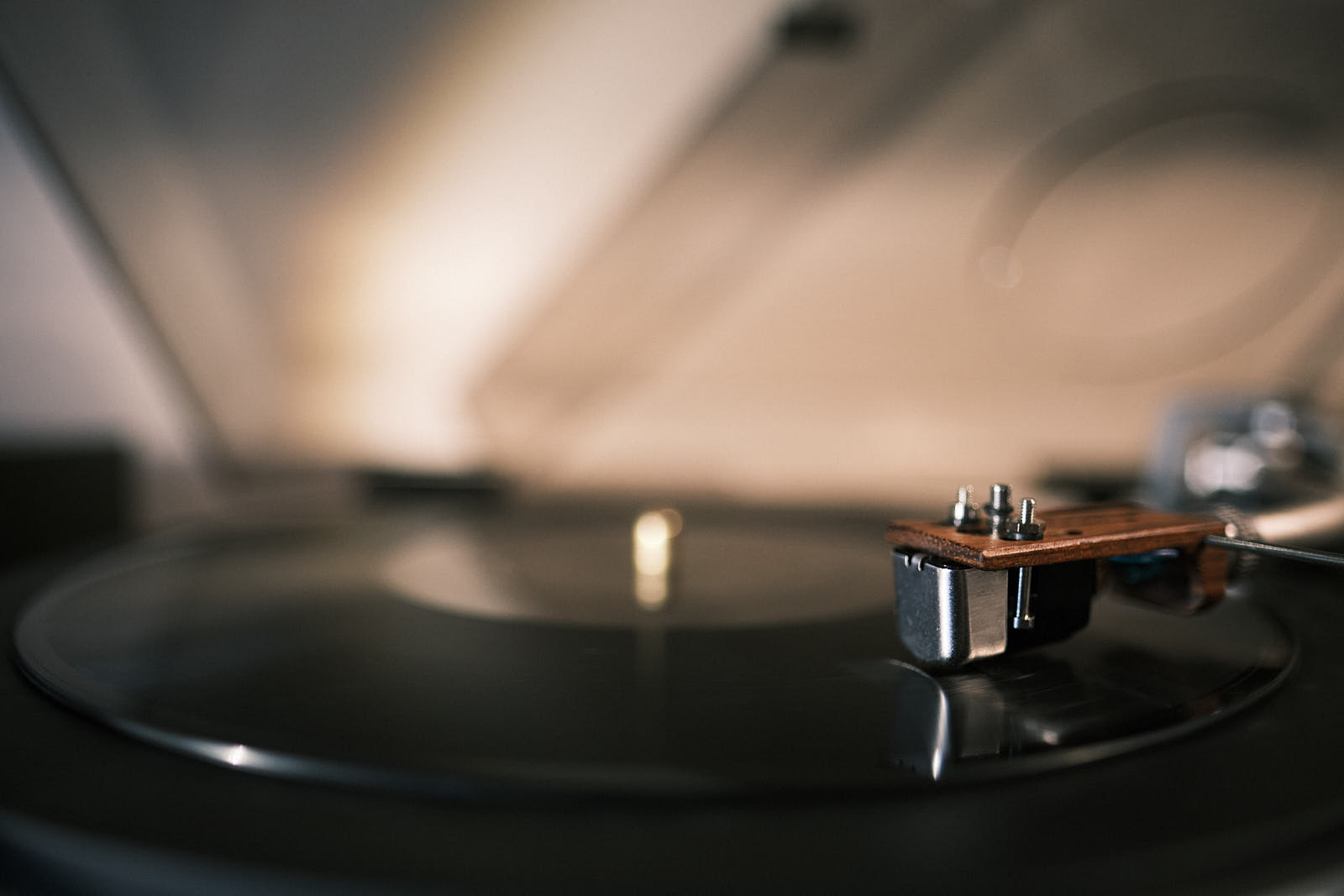 A cartridge and stylus reading the grooves of a record